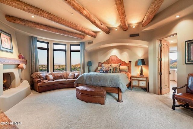 bedroom with beam ceiling and carpet flooring