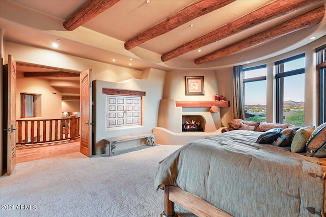 bedroom with beam ceiling and hardwood / wood-style floors