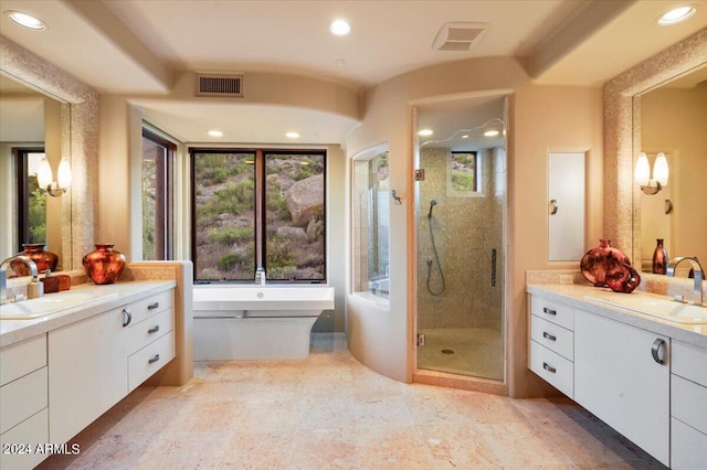 bathroom featuring dual bowl vanity, independent shower and bath, and tile floors