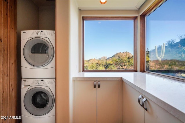 clothes washing area with stacked washer and dryer