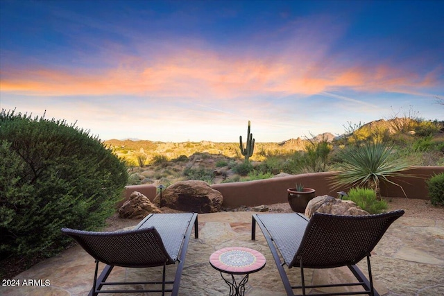 view of patio terrace at dusk