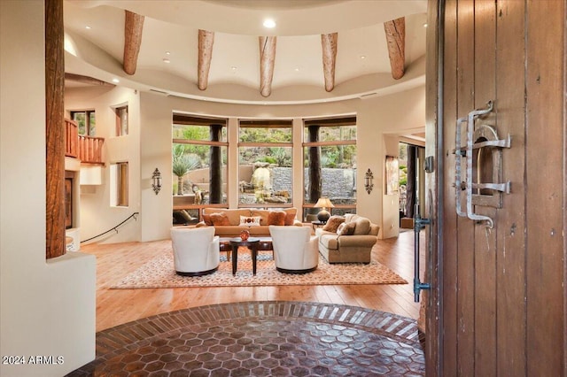 living room with beamed ceiling and hardwood / wood-style flooring