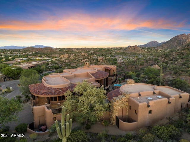 aerial view at dusk featuring a mountain view