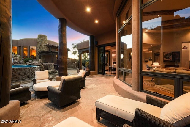 patio terrace at dusk featuring outdoor lounge area