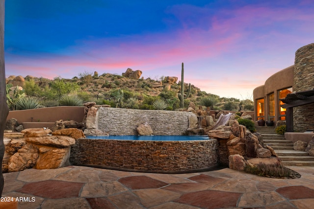 view of patio terrace at dusk