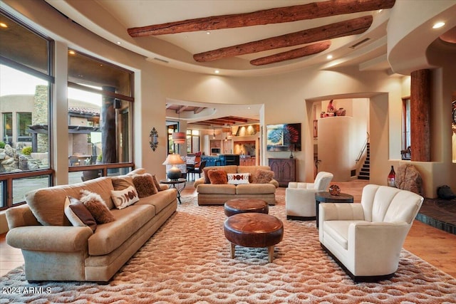 living room with beam ceiling, ceiling fan, and hardwood / wood-style floors