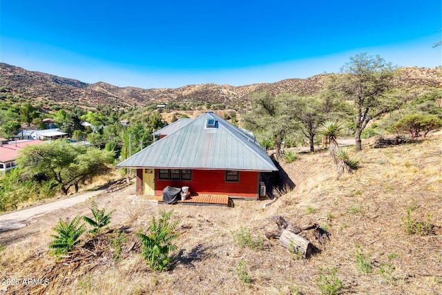 816 Tombstone Cyn Unit C, Bisbee, AZ 85603 - view of side of home with a mountain view and a metal roof