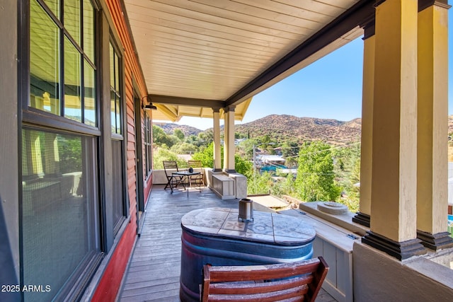 816 Tombstone Cyn Unit C, Bisbee, AZ 85603 - wooden deck featuring a mountain view and outdoor dining area