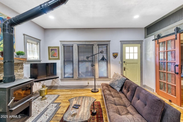 816 Tombstone Cyn Unit C, Bisbee, AZ 85603 - living area featuring a wood stove, wood finished floors, recessed lighting, and a barn door