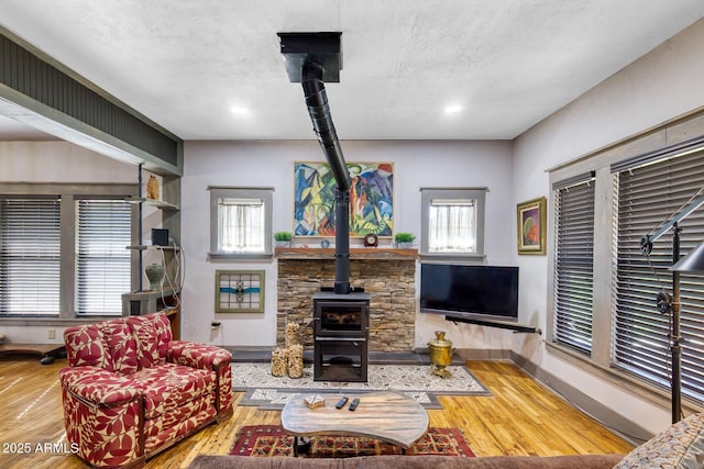 816 Tombstone Cyn Unit C, Bisbee, AZ 85603 - living room with a wood stove, wood finished floors, and recessed lighting