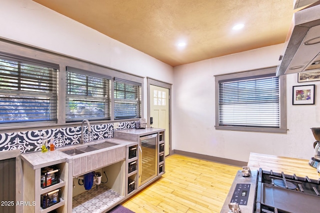 816 Tombstone Cyn Unit C, Bisbee, AZ 85603 - kitchen with ventilation hood, healthy amount of natural light, light wood-type flooring, light countertops, and recessed lighting
