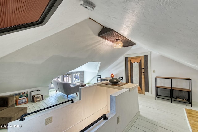 816 Tombstone Cyn Unit C, Bisbee, AZ 85603 - additional living space featuring hardwood / wood-style floors, vaulted ceiling, and a textured ceiling