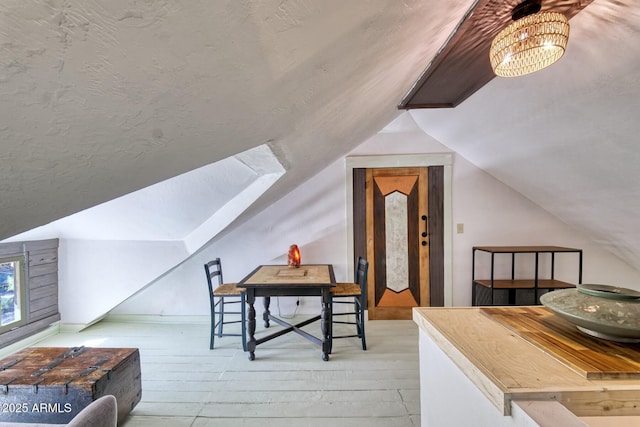 816 Tombstone Cyn Unit C, Bisbee, AZ 85603 - bonus room featuring lofted ceiling, wood-type flooring, and a chandelier