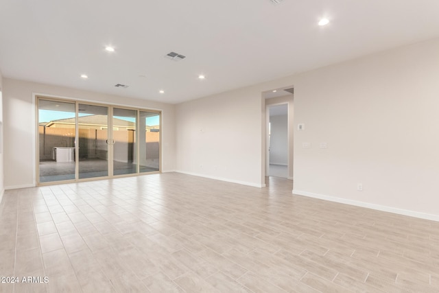 spare room featuring light hardwood / wood-style flooring