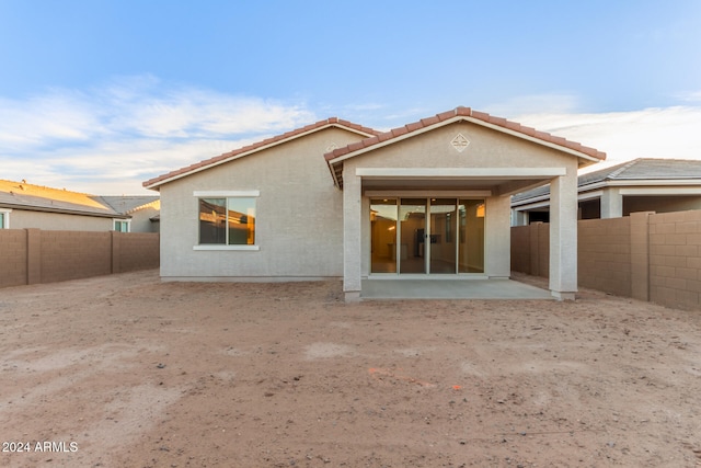 back of house with a patio