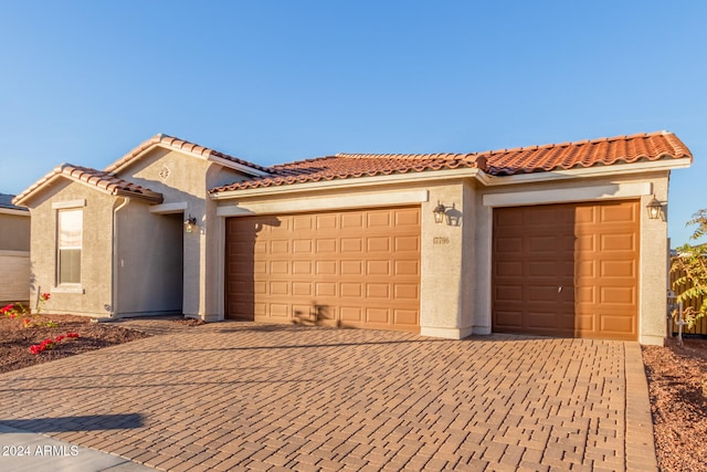 mediterranean / spanish-style home with a garage