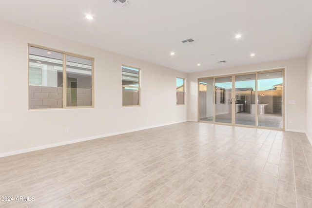 unfurnished room with light wood-type flooring