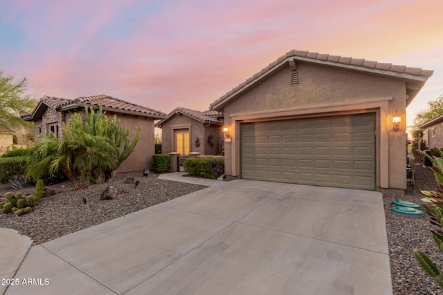 20558 N 263rd Dr, Buckeye, AZ 85396 - view of front of home with an attached garage, stucco siding, concrete driveway, and a tile roof