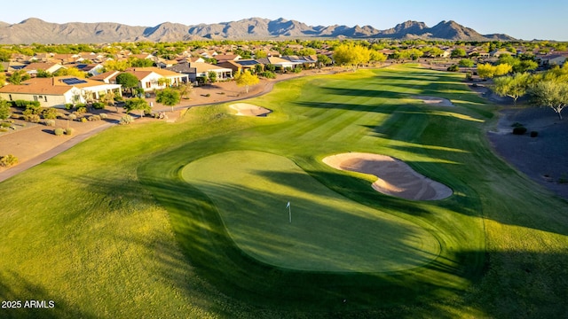 view of community featuring a residential view, view of golf course, and a mountain view