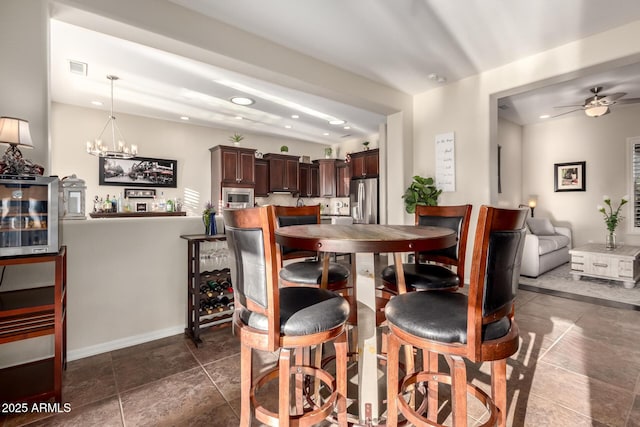 dining area featuring recessed lighting, baseboards, ceiling fan with notable chandelier, and visible vents