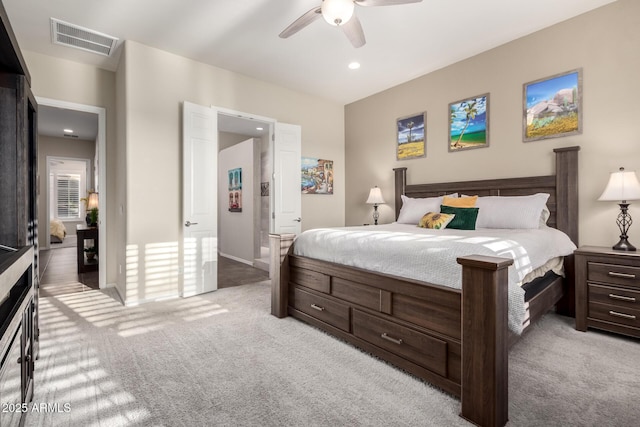 bedroom with light colored carpet, a ceiling fan, visible vents, and recessed lighting