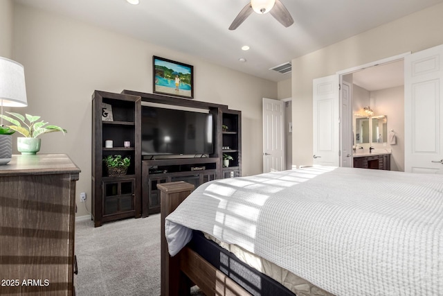 bedroom featuring visible vents, ceiling fan, light colored carpet, recessed lighting, and ensuite bath
