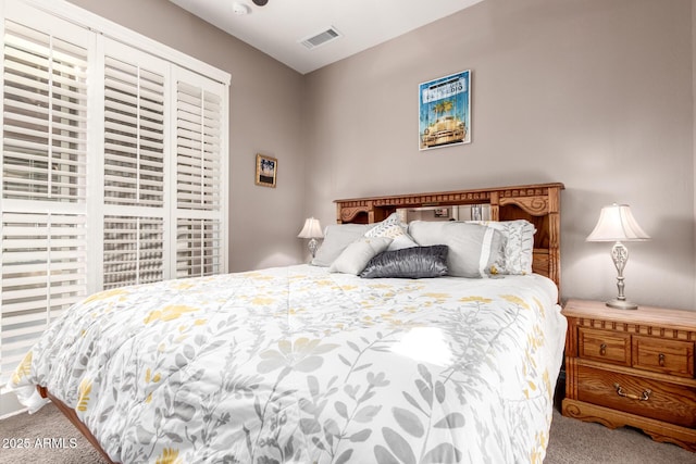 bedroom with carpet floors and visible vents
