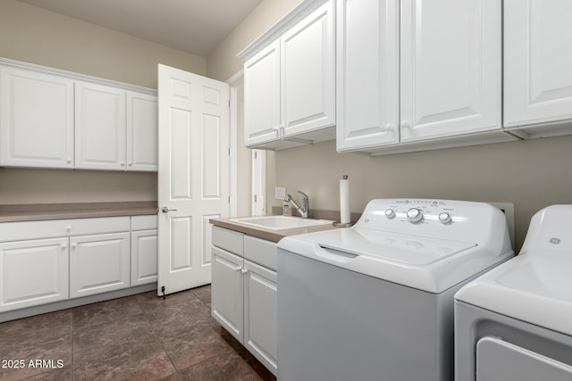 laundry room featuring a sink, cabinet space, and independent washer and dryer