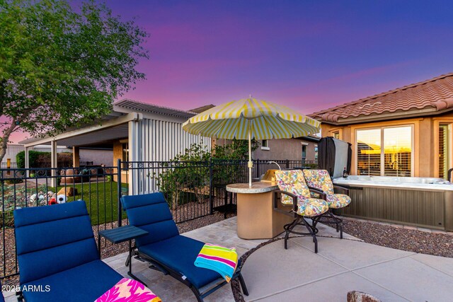 patio terrace at dusk with fence and outdoor dry bar