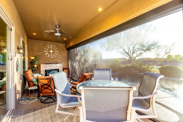 view of patio / terrace with outdoor dining area, a ceiling fan, and fence