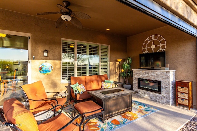 view of patio / terrace featuring an outdoor living space with a fireplace and ceiling fan