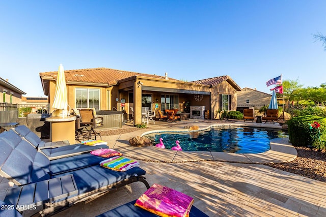 outdoor pool featuring fence, a patio area, and outdoor dry bar
