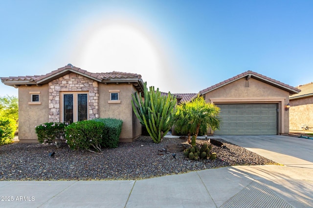 ranch-style home featuring an attached garage, a tile roof, stone siding, stucco siding, and driveway