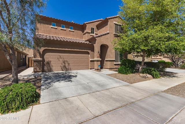6746 W Wethersfield Rd, Peoria, AZ 85381 - mediterranean / spanish-style house with a garage, stucco siding, concrete driveway, and a tile roof