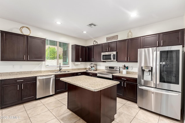 6746 W Wethersfield Rd, Peoria, AZ 85381 - kitchen with dark brown cabinetry, light countertops, visible vents, appliances with stainless steel finishes, and a sink