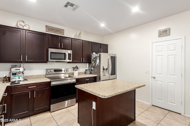6746 W Wethersfield Rd, Peoria, AZ 85381 - kitchen featuring light tile patterned floors, visible vents, light countertops, and appliances with stainless steel finishes