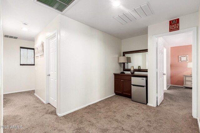 6746 W Wethersfield Rd, Peoria, AZ 85381 - hall featuring light carpet, visible vents, and baseboards
