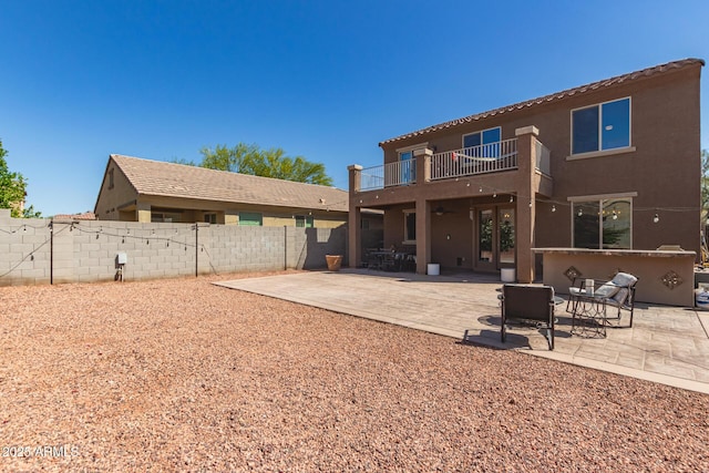 6746 W Wethersfield Rd, Peoria, AZ 85381 - back of house featuring a patio, a balcony, stucco siding, and fence