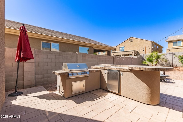 6746 W Wethersfield Rd, Peoria, AZ 85381 - view of patio with a grill, an outdoor kitchen, and a fenced backyard