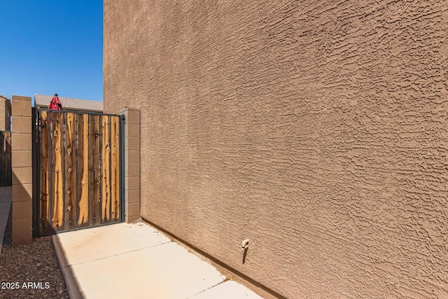 6746 W Wethersfield Rd, Peoria, AZ 85381 - view of property exterior with stucco siding and a gate