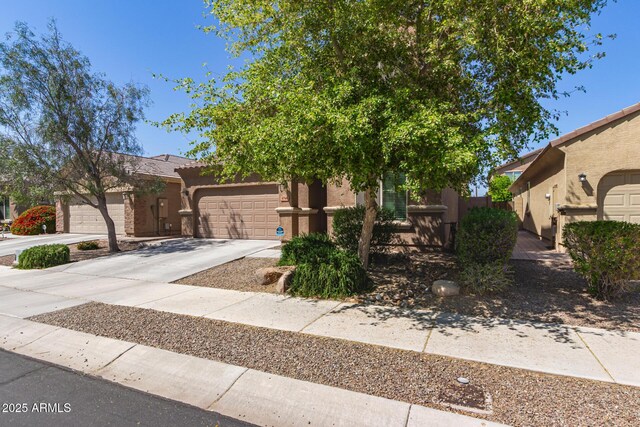 6746 W Wethersfield Rd, Peoria, AZ 85381 - view of front of house featuring stucco siding, a garage, and concrete driveway