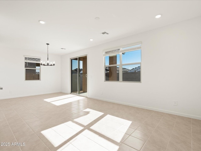 unfurnished room featuring an inviting chandelier and light tile patterned floors