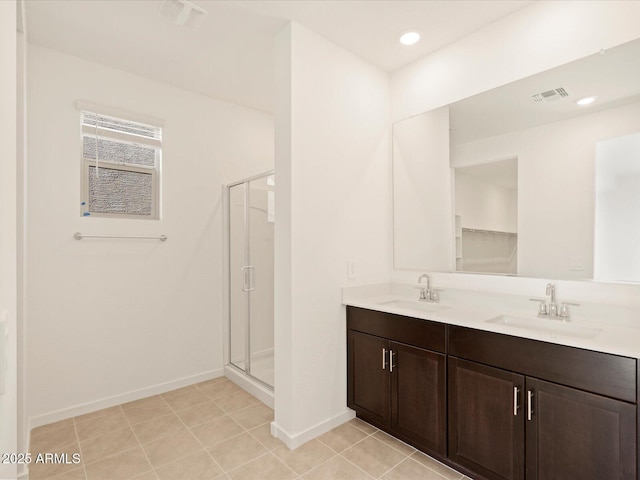 bathroom featuring an enclosed shower, vanity, and tile patterned flooring