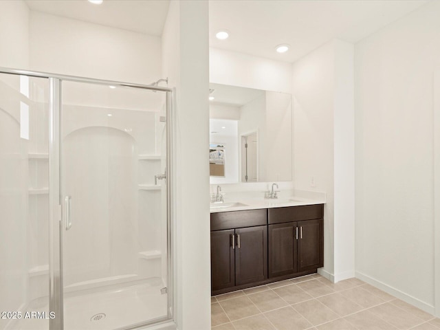 bathroom featuring walk in shower, tile patterned floors, and vanity