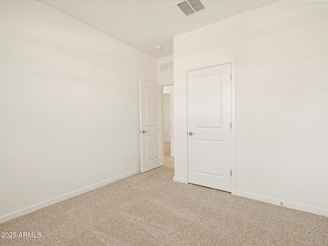 unfurnished room with light colored carpet