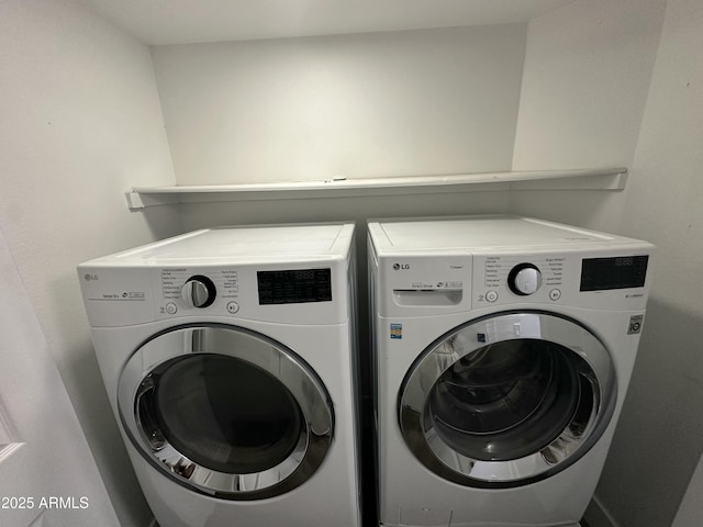 clothes washing area with washer and clothes dryer