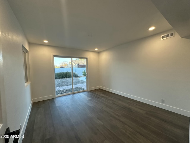 spare room featuring dark hardwood / wood-style flooring