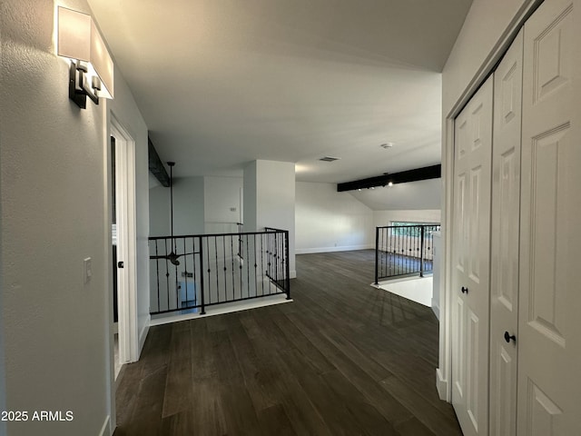 corridor featuring vaulted ceiling with beams and dark hardwood / wood-style flooring