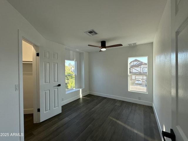 empty room with ceiling fan and dark hardwood / wood-style floors