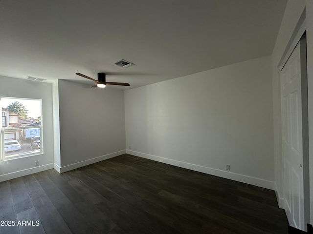 unfurnished room with ceiling fan and dark hardwood / wood-style flooring